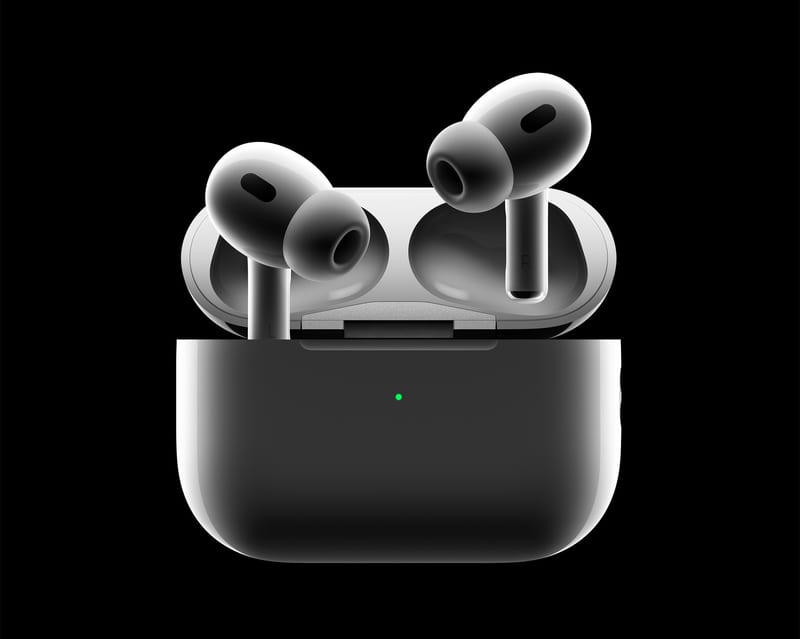 Second-generation Apple AirPods Pro in white above their open MagSafe charging case on a black background